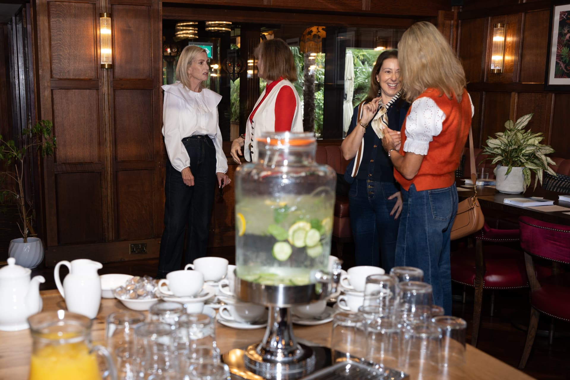 Women chatting and laughing at a Her Rising Soul gathering