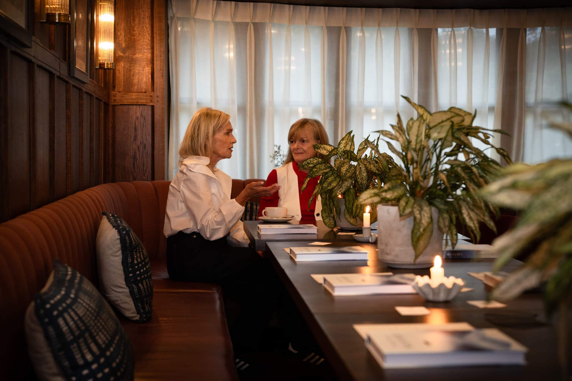 Two women in conversation over coffee